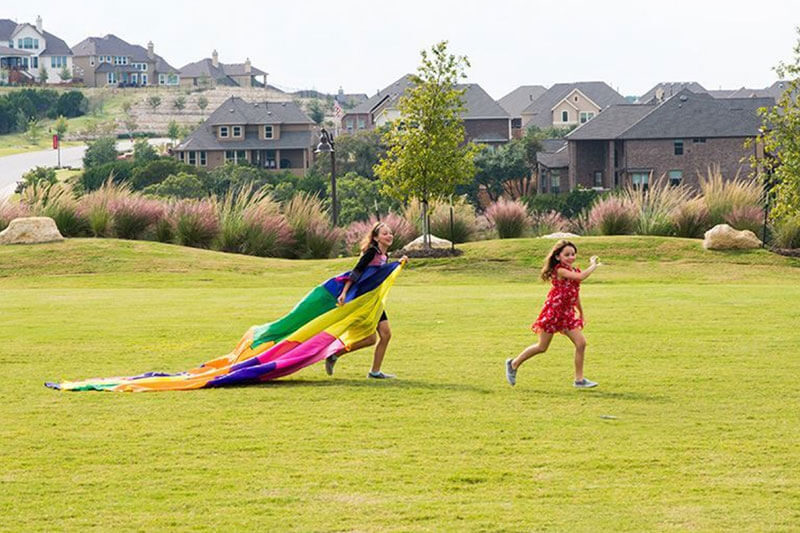 Kids playing outdoors at Sweetwater community Austin, Texas