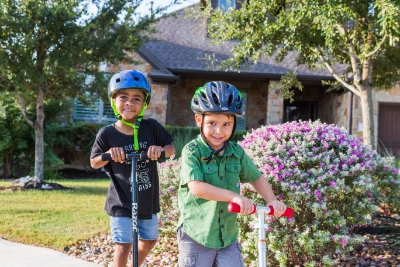 kids-riding-scooters-on-sidewalk.jpg